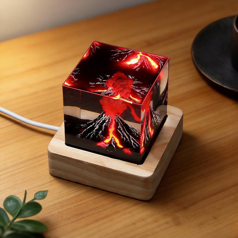 Erupting volcano resin cube lamp on a wood desk