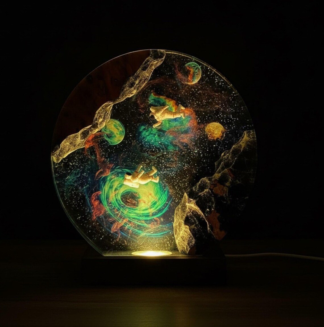 Astronaut galaxy resin lamp glowing warm in a dark room