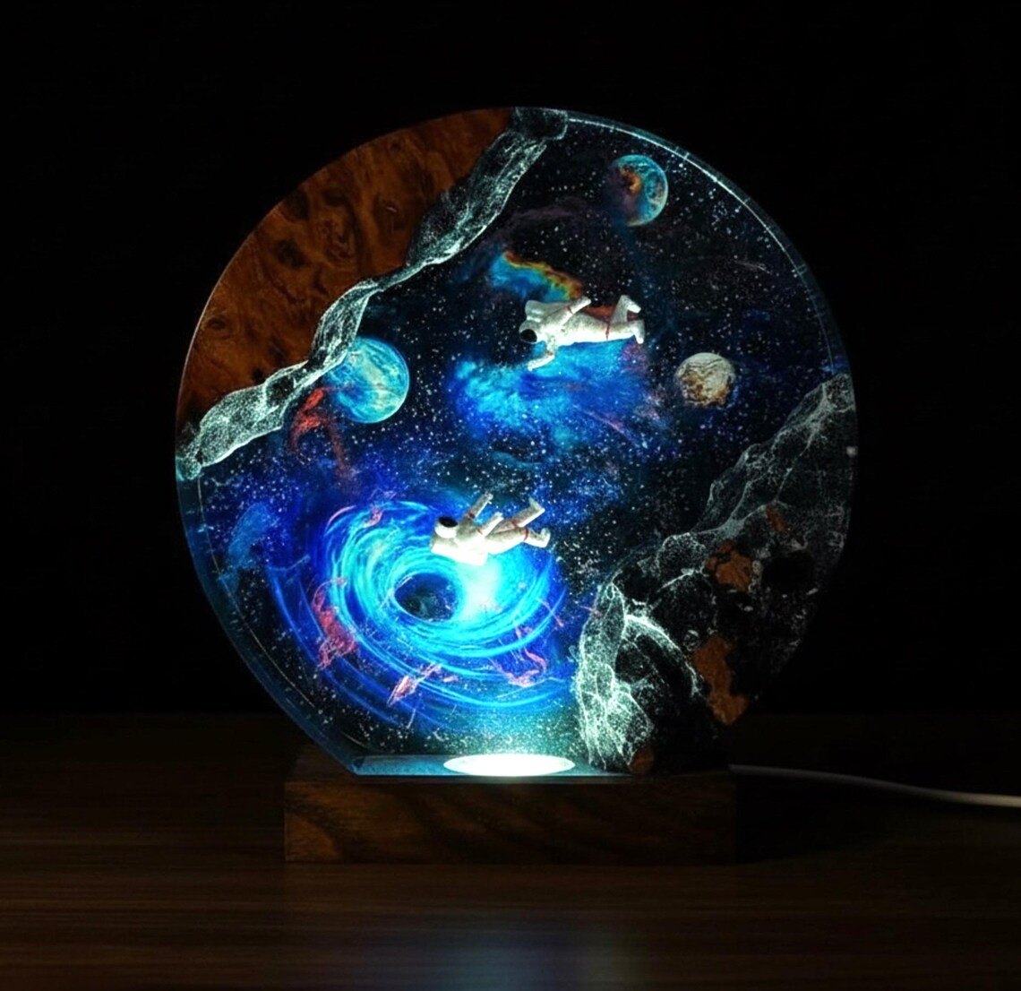Astronaut resin night light glowing cool blue in the dark
