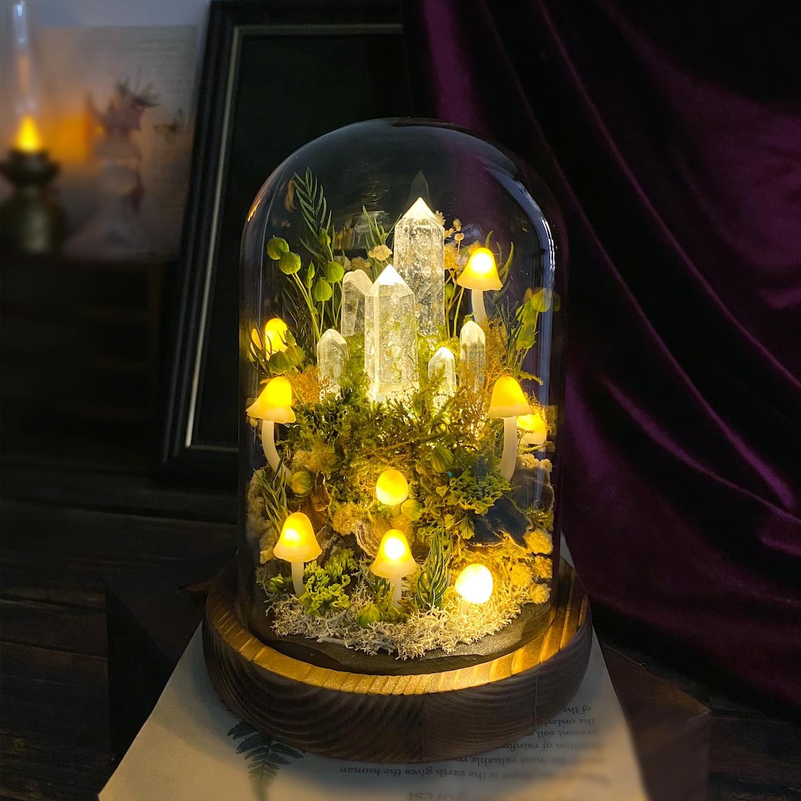 Mushroom night light glass dome with crystals beside a candle