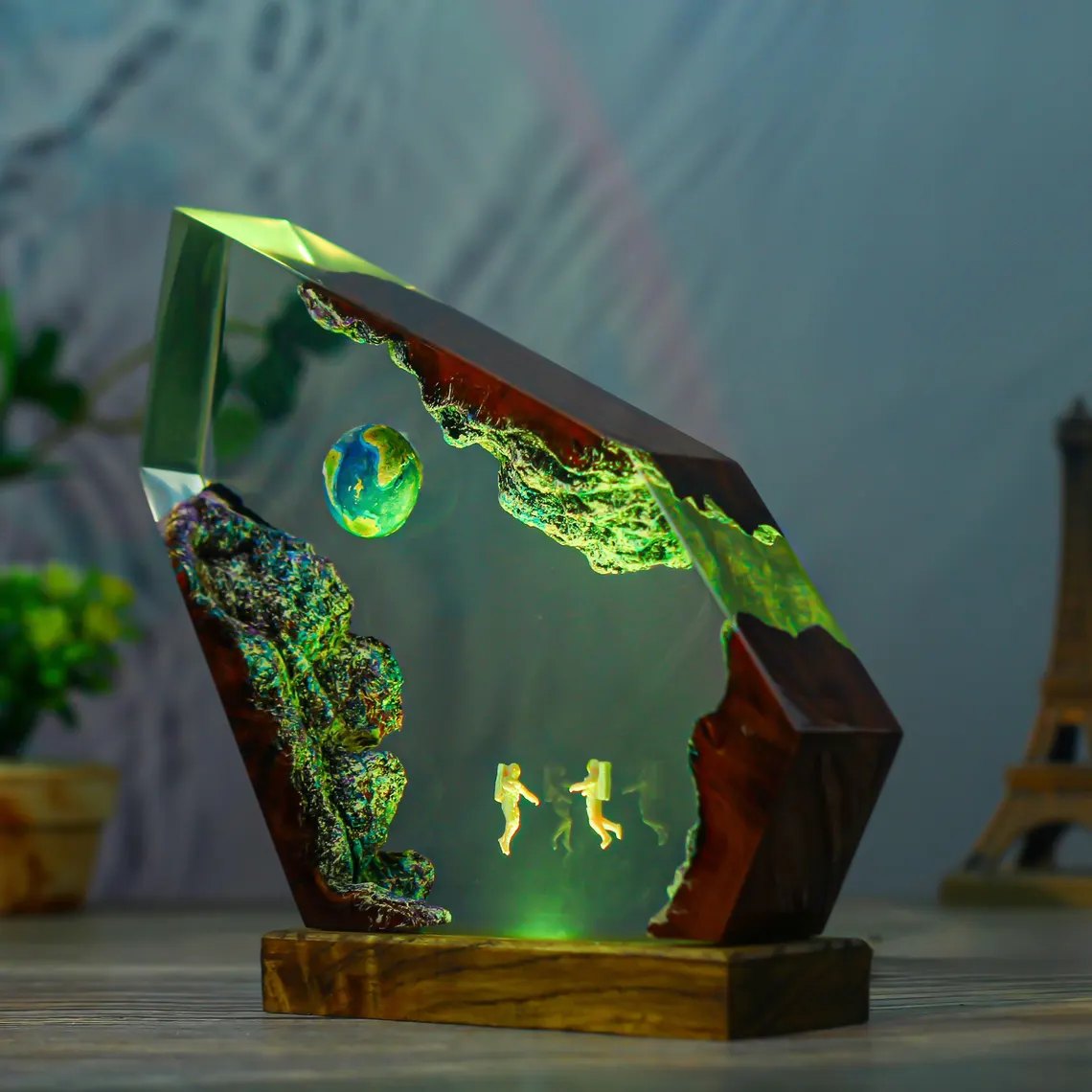 Astronaut and Earth resin lamp glowing green, side view