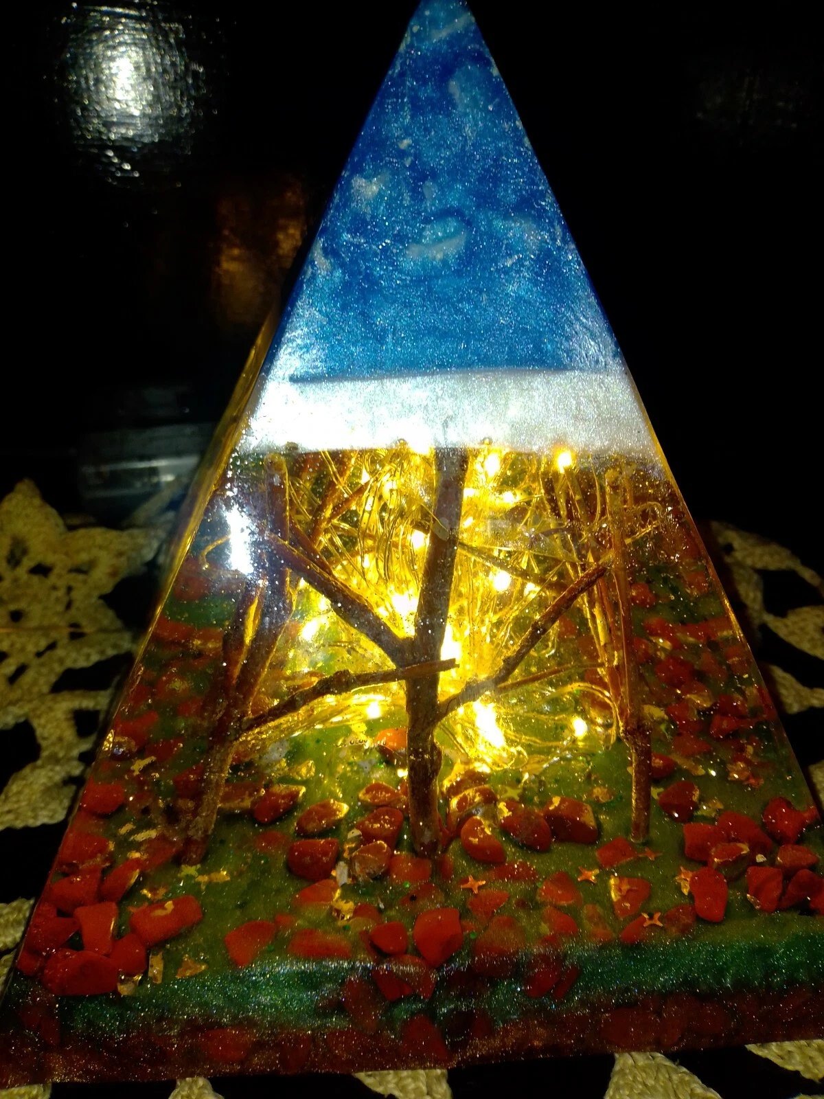 Forest resin pyramid lamp with twig trees and warm fairy lights, front view