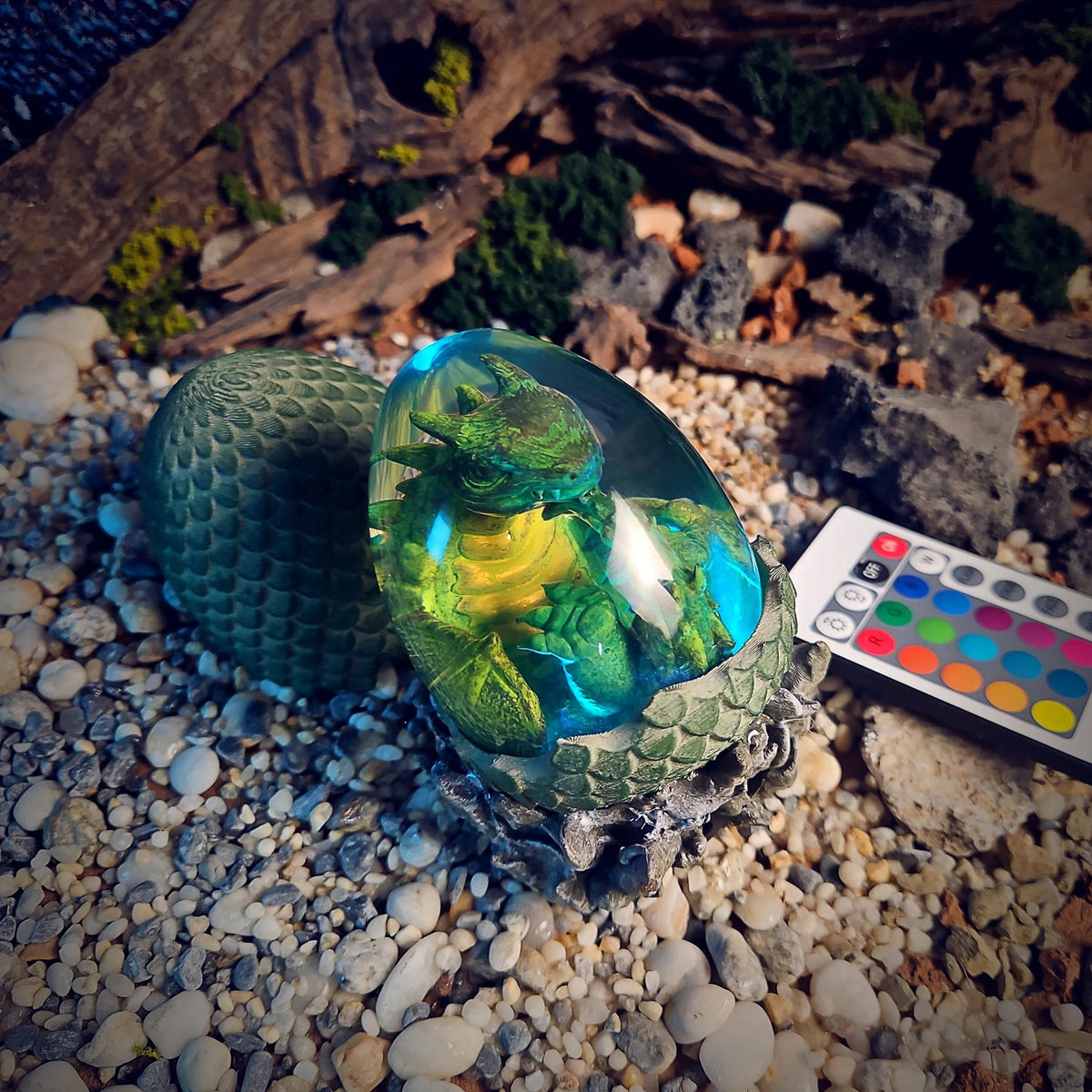 Dragon egg lamp with green hatchling glowing cyan and yellow