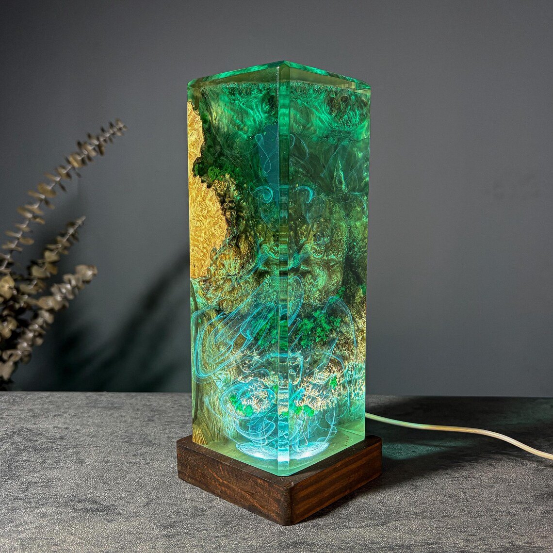 Moss resin lamp corner view with burl wood edge, teal glow