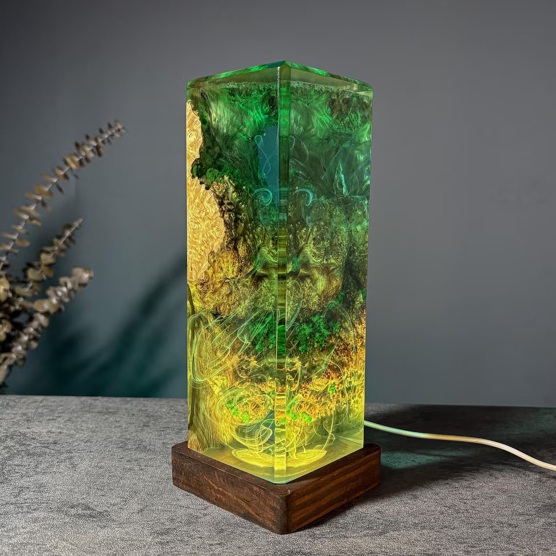 Moss resin lamp angled view glowing yellow-green