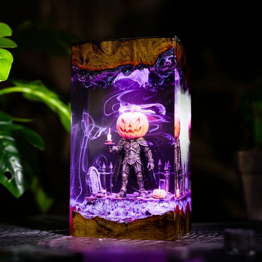 Close-up of pumpkin knight holding a candle in purple light