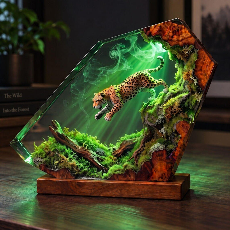 Leaping jaguar resin lamp glowing green on a wooden desk