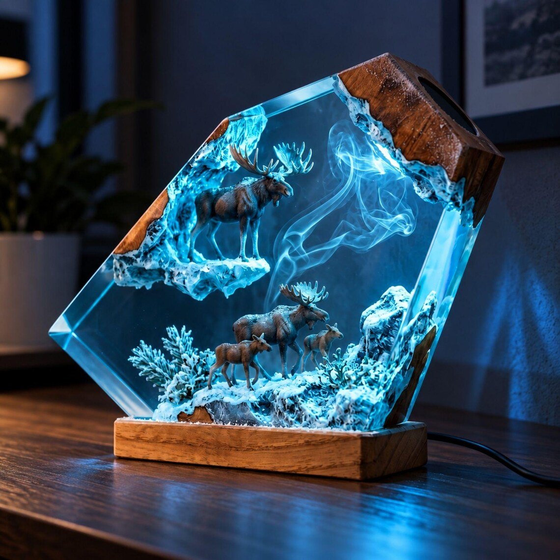 Moose family resin lamp lit in blue on a dark desk