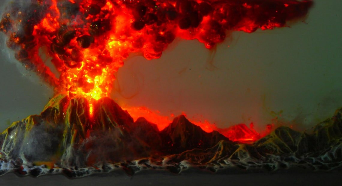 Erupting volcano crater and ash cloud in the resin block