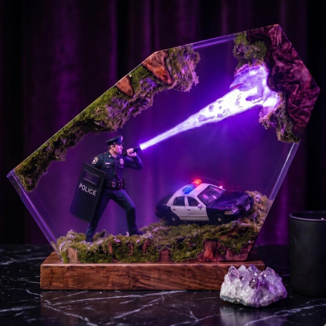 Police resin lamp glowing purple on a marble surface
