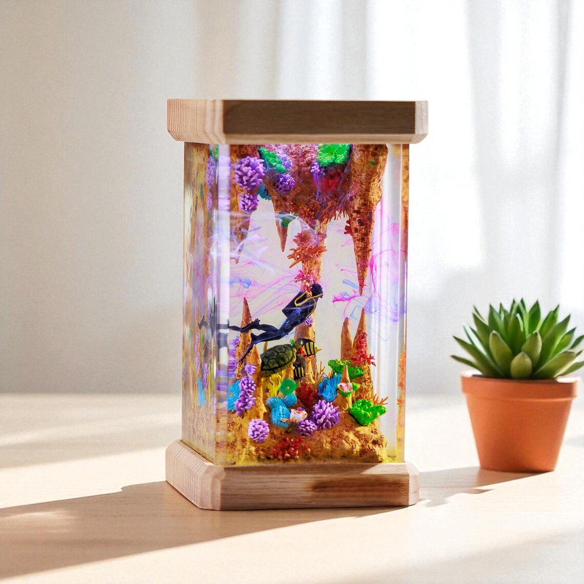 Sea cave resin lamp in sunlight beside a succulent