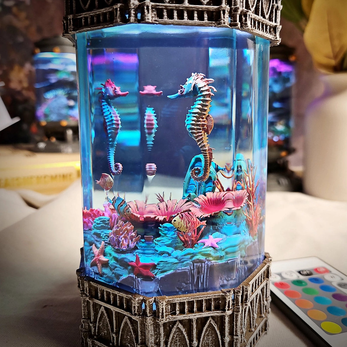 Close-up of seahorses and starfish in the glowing lamp