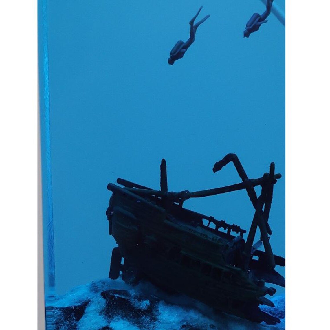 Close-up of two divers above the sunken ship