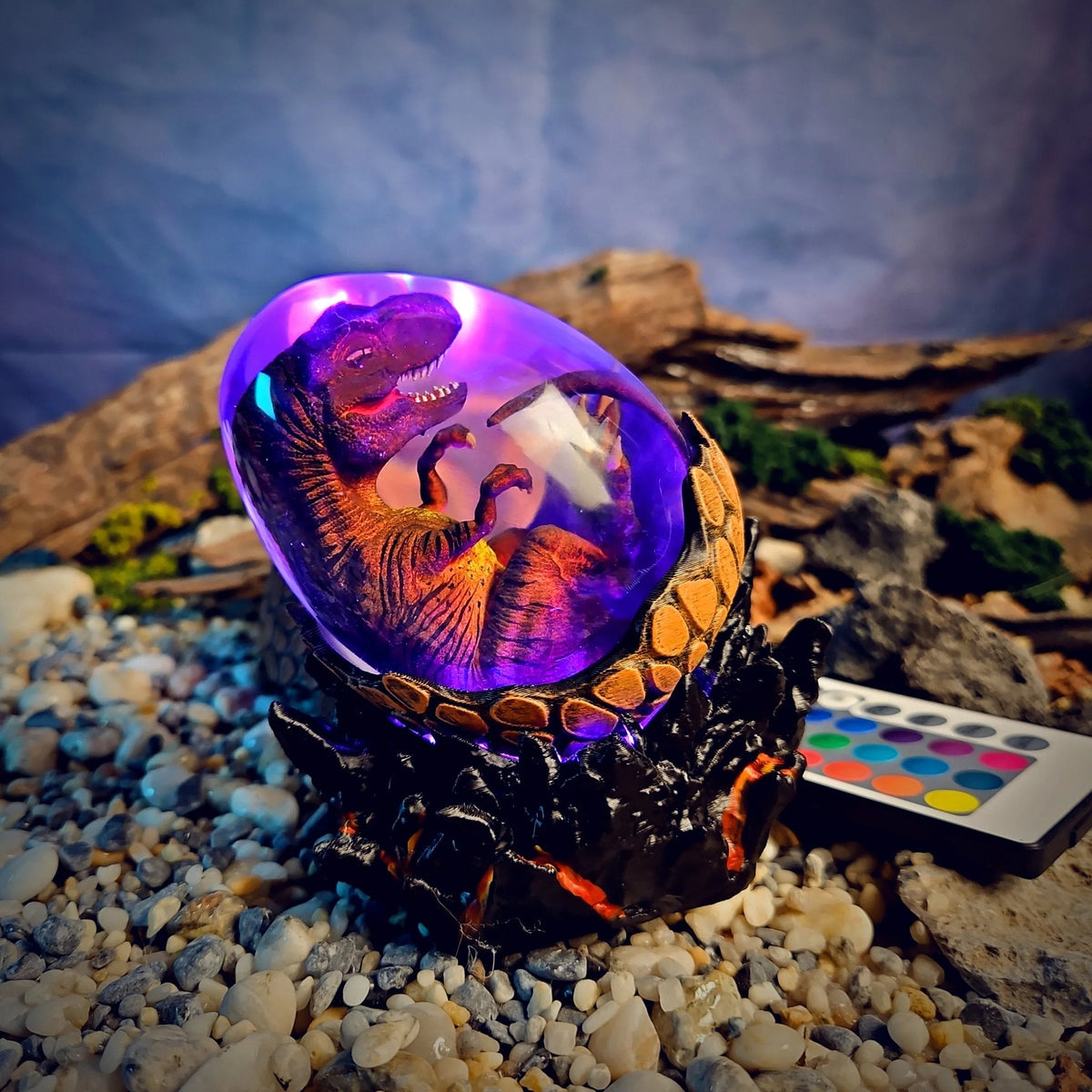 T-Rex embryo egg lamp glowing violet on a lava-crack base