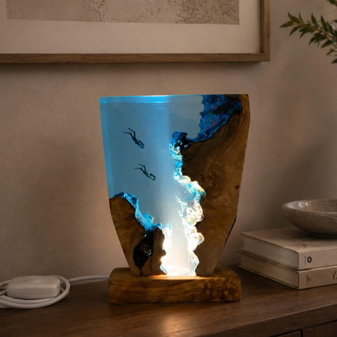 Front view of two divers and surf wall in resin