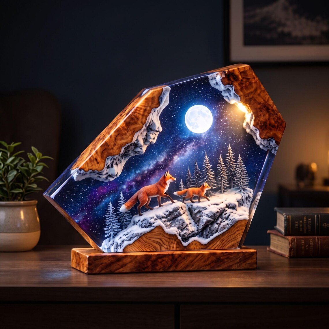Two foxes resin lamp on a sideboard beside books