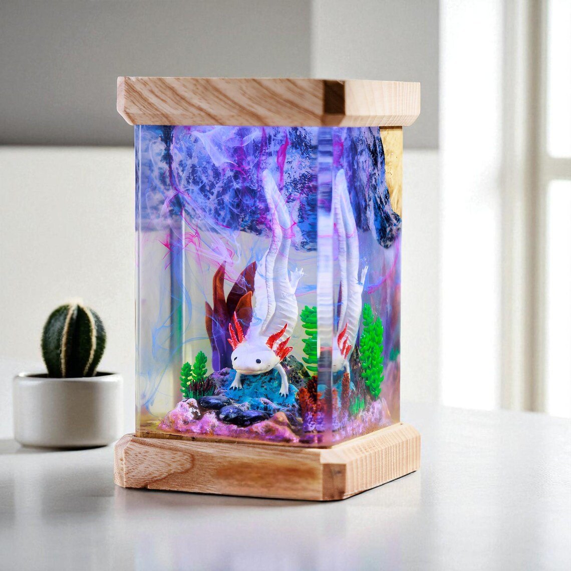 Axolotl resin lamp beside a small cactus near a window